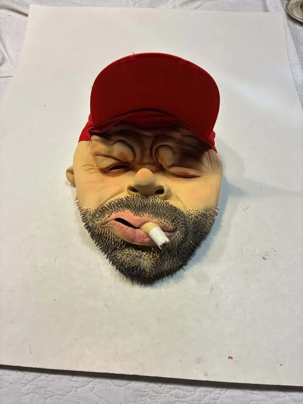 Realistic Man with Beard and Cigarette Latex Novelty Mask with Red Cap